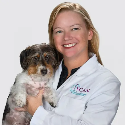 Dr. Carnes holding a scruffy dog